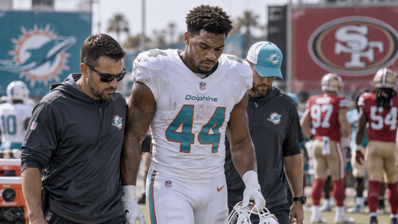 Miami Dolphins edge rusher Chop Robinson leaving the field with staff before the Week 2 matchup with the 49ers.