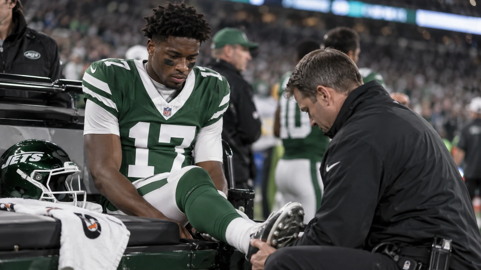 New York Jets wide receiver receiving sideline treatment for an ankle injury